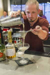 Joel Atlas, beverage manager at Rossetti Restaurant, pours his brandy-based cocktail. 