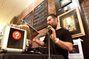 DJ Seth Albaum spins locals records during the Vinyl Open Mic Series at White Rose Coffeehouse in Central Square. | Photo: Nicole Goodhue Boyd