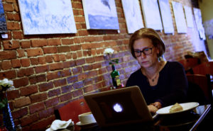Anne Principe of Swampscott enjoys breakfast while doing some work at White Rose Coffeehouse. | Photo: Mark Lorenz